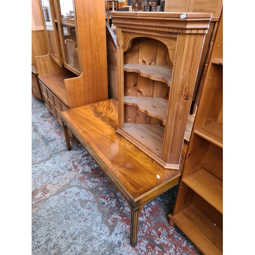 576 - A pine wall mountable corner cabinet and a mahogany effect rectangular coffee table