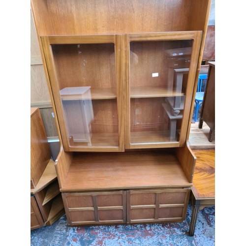 577 - A Nathan teak wall unit with two upper glazed doors and two lower cupboard doors - measuring approx.... 