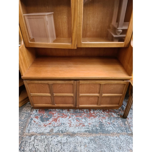 577 - A Nathan teak wall unit with two upper glazed doors and two lower cupboard doors - measuring approx.... 