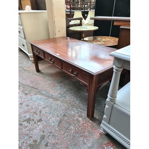 584 - A mahogany rectangular coffee table with three drawers