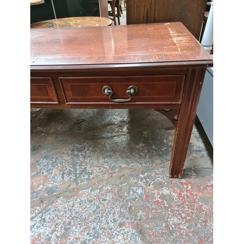 584 - A mahogany rectangular coffee table with three drawers