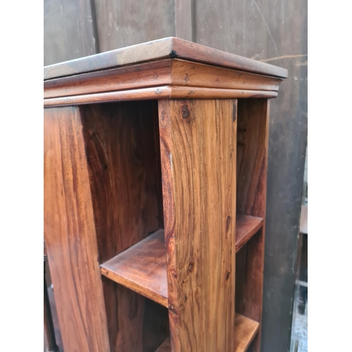 588 - An Indian sheesham wood revolving CD rack - measuring approx. 112cm high