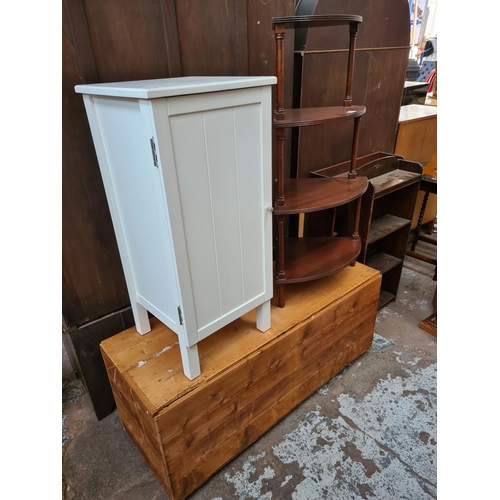 589 - Three items to include a mahogany four tier whatnot stand, white painted bathroom cabinet and a pine... 