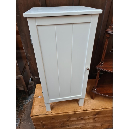 589 - Three items to include a mahogany four tier whatnot stand, white painted bathroom cabinet and a pine... 