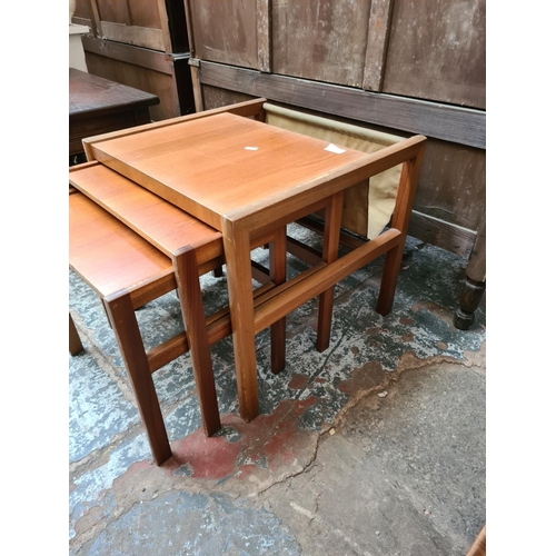 590 - A teak nest of three tables