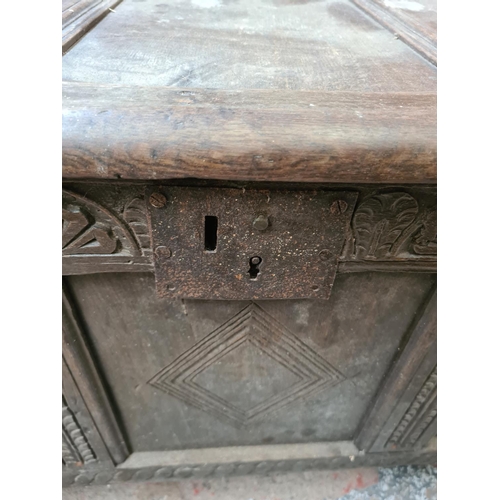 593 - An 18th century oak coffer - measuring approx. 59cm high, 115cm wide and 53cm deep (see condition re... 