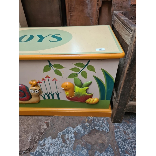 595 - A modern painted child's toy box with insect design - measuring approx. 44cm high, 88cm wide and 37c... 