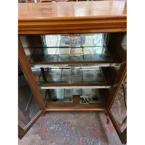 599 - A walnut display cabinet on cabriole supports with two glazed doors and mirrored interior - measurin... 