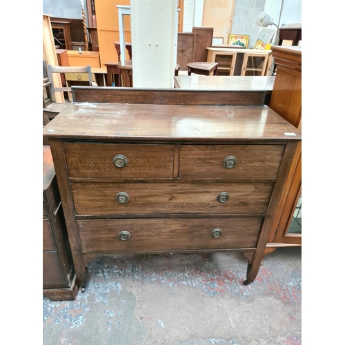 600 - An early 20th century oak chest of two short over two long drawers - measuring approx. 97cm high, 99... 