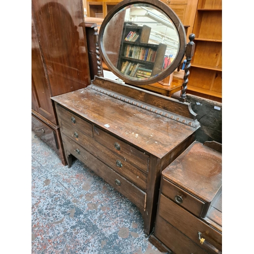 602 - An early 20th century oak dressing table with two short over two long drawers and upper bevel edged ... 