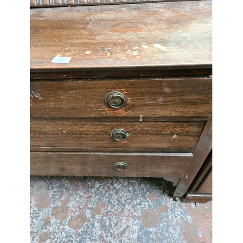 602 - An early 20th century oak dressing table with two short over two long drawers and upper bevel edged ... 