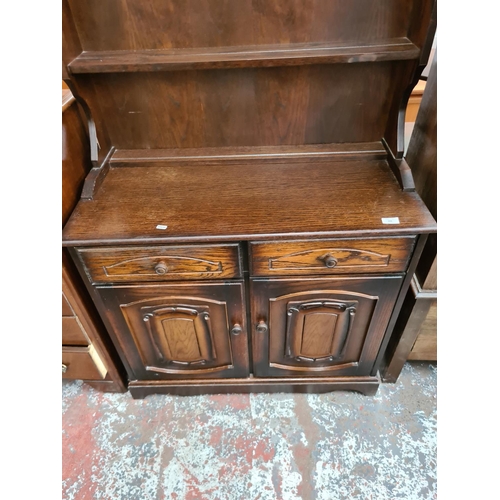 606 - An oak Dutch dresser with upper plate rack, two drawers and two doors - measuring approx. 183cm high... 