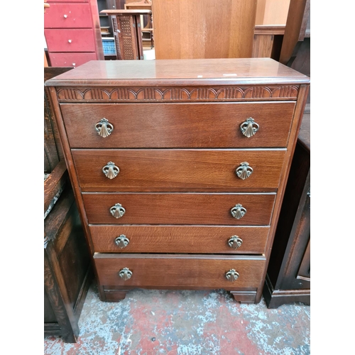 607 - An Art Deco oak chest of five drawers - measuring approx. 103cm high, 77cm wide and 41.5cm deep