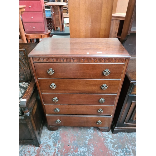 607 - An Art Deco oak chest of five drawers - measuring approx. 103cm high, 77cm wide and 41.5cm deep