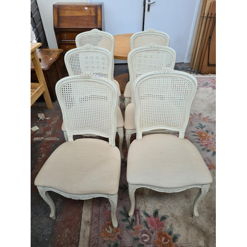 616 - Six French style white painted dining chairs with rattan backs and cream upholstery (see condition r... 