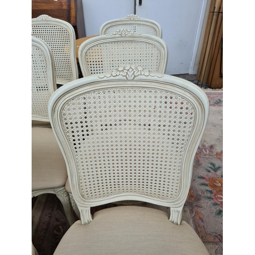 616 - Six French style white painted dining chairs with rattan backs and cream upholstery (see condition r... 