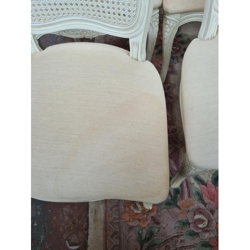 616 - Six French style white painted dining chairs with rattan backs and cream upholstery (see condition r... 