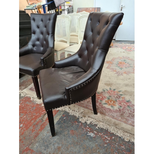 617 - A pair of brown leatherette metal studded dining chairs with chrome hoop backs