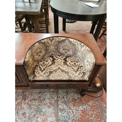 623 - An oak telephone table with green upholstered seat and one cupboard door - measuring approx. 70cm hi... 