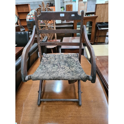 636 - A WW1 military campaign chair with later upholstered seat