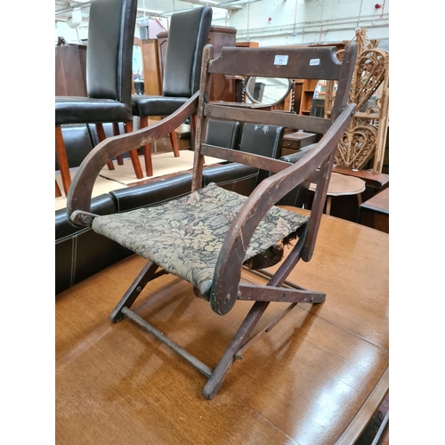 636 - A WW1 military campaign chair with later upholstered seat