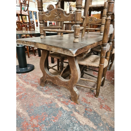 642 - An 18th century style oak plank top refectory dining table and six matching ladder back dining chair... 