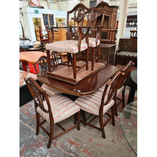 644 - A Bevan Funnell Reprodux mahogany extending dining table and eight matching shield back dining chair... 