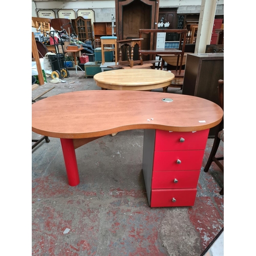 645 - A modern cherrywood effect kidney shaped office desk with four drawers.  Top measures 144cm long and... 