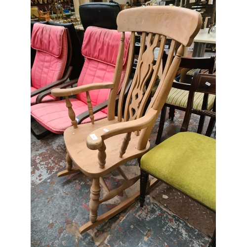 654 - A Victorian style solid beech farmhouse rocking chair with carved fretwork back - measuring approx. ... 