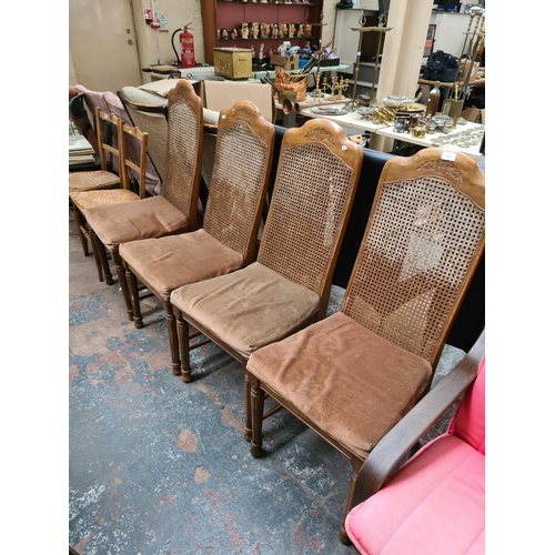 656 - Four French style walnut dining chairs with rattan backs and brown upholstery