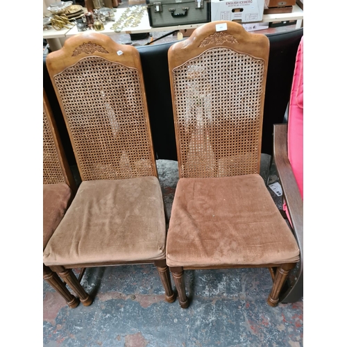 656 - Four French style walnut dining chairs with rattan backs and brown upholstery