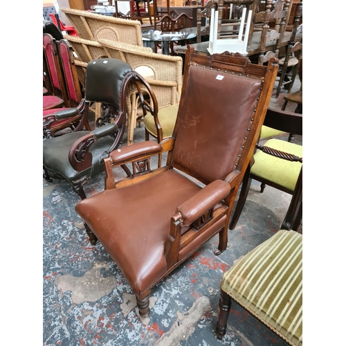 658 - An Edwardian oak framed parlour chair with brown leatherette upholstery - measuring approx. 106cm hi... 