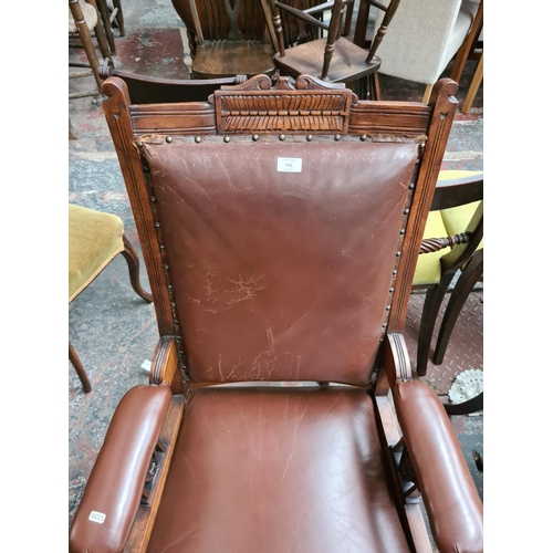 658 - An Edwardian oak framed parlour chair with brown leatherette upholstery - measuring approx. 106cm hi... 