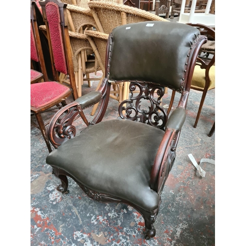 659 - A Victorian carved mahogany parlour chair with fretwork back and green leather upholstery - measurin... 