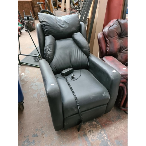 662A - A modern black leatherette rise and recline mobility armchair