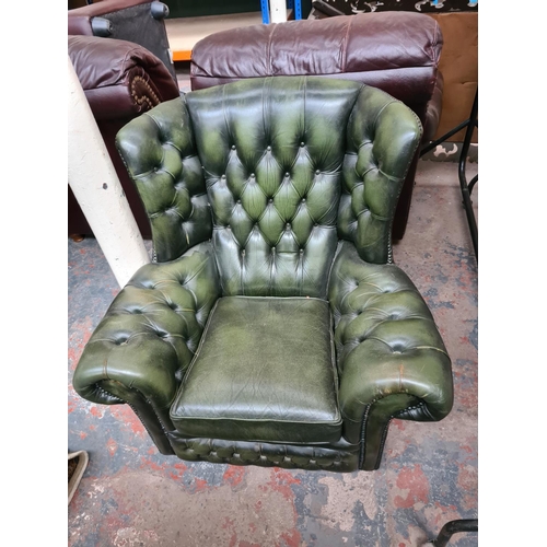 662C - A Chesterfield style green leather three piece lounge suite comprising three seater sofa and two arm... 