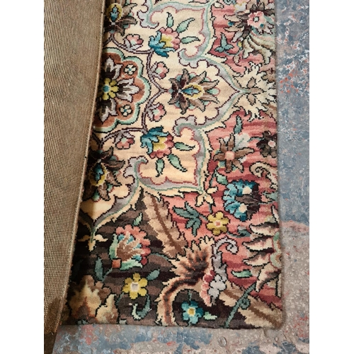 662E - A large floral patterned rectangular rug in the manner of Axminster - made by strip carpet (Approx. ... 