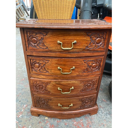 647A - An oriental style carved rosewood effect four drawer cabinet with brass inlay and swan neck handles ... 