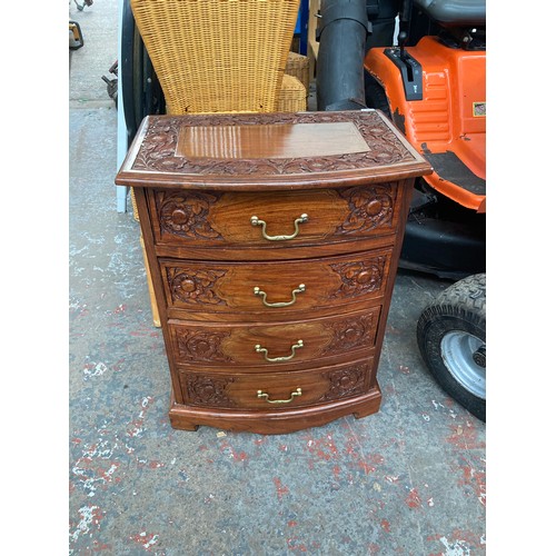 647A - An oriental style carved rosewood effect four drawer cabinet with brass inlay and swan neck handles ... 