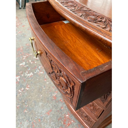 647A - An oriental style carved rosewood effect four drawer cabinet with brass inlay and swan neck handles ... 