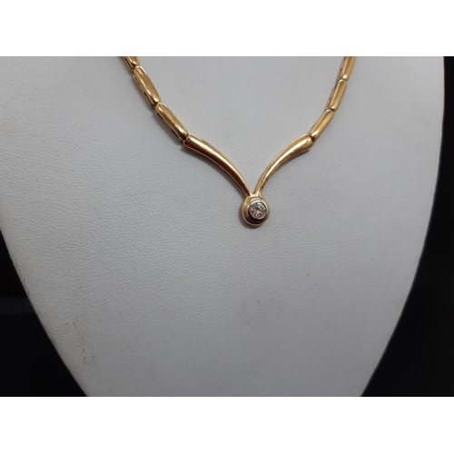 103 - A hallmarked 18ct yellow gold ladies necklace with inset 0.2ct diamond - approx. total weight 24 gra... 