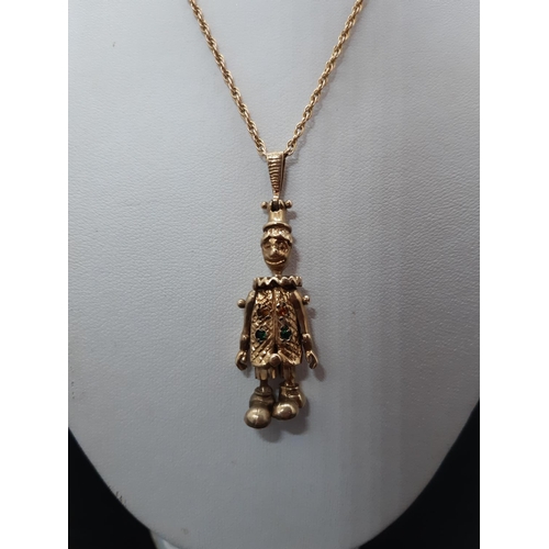 104 - A hallmarked 9ct gold necklace with hallmarked 9ct gold articulated clown pendant with inset stones ... 