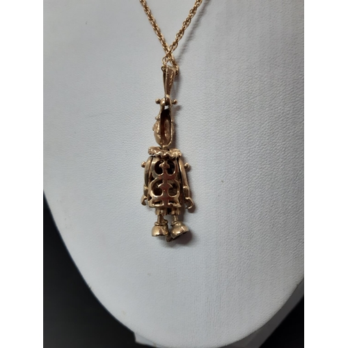 104 - A hallmarked 9ct gold necklace with hallmarked 9ct gold articulated clown pendant with inset stones ... 