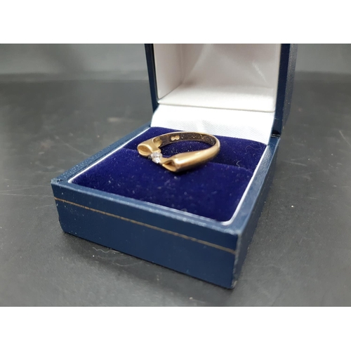 108 - A hallmarked 18ct gold bow shaped ring with inset diamond - approx. total weight 2.8 grams and size ... 