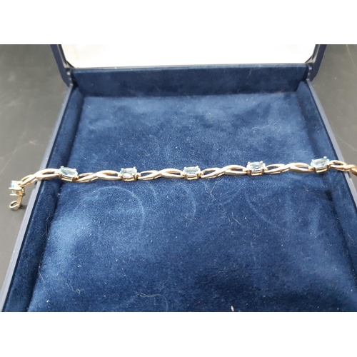 110 - A hallmarked 9ct gold bracelet with inset topaz stones - approx. total weight 4.4 grams