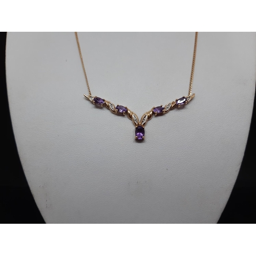 112 - A hallmarked 9ct gold 'V' shaped necklace with inset amethysts - approx. total weight 4.2 grams