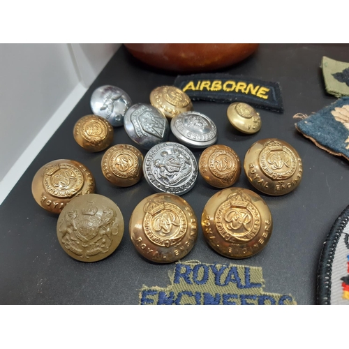 127 - A lord Hamlet cigar box containing a collection of Royal Engineers buttons and various cloth uniform... 