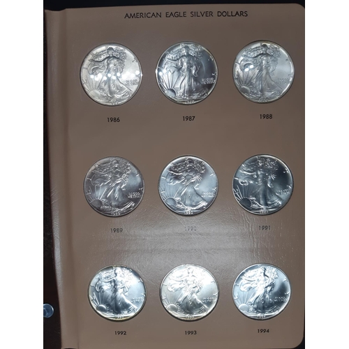 138 - A Dansco Archival slipcased coin album containing 32 american eagle silver dollars ranging from 1986... 