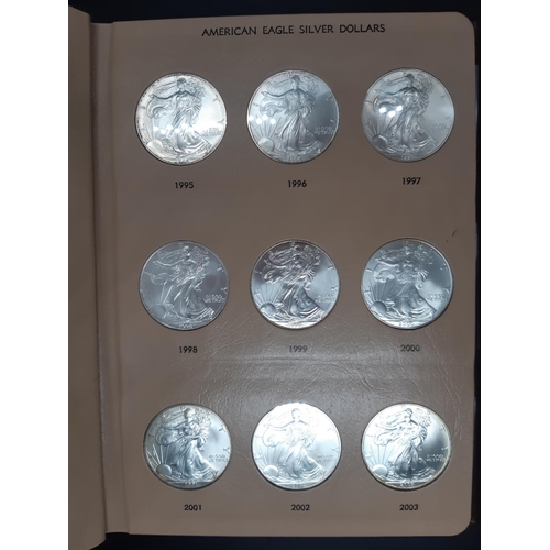 138 - A Dansco Archival slipcased coin album containing 32 american eagle silver dollars ranging from 1986... 