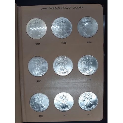 138 - A Dansco Archival slipcased coin album containing 32 american eagle silver dollars ranging from 1986... 